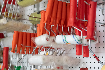 Roller for painting walls on the shelf in the store