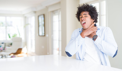 African American man at home shouting and suffocate because painful strangle. Health problem. Asphyxiate and suicide concept.