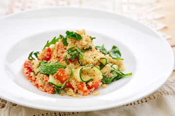 An easy, zesty summer salad with a Mediterranean flair featuring Israeli couscous and chopped summer vegetables