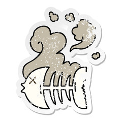 distressed sticker of a quirky hand drawn cartoon dead fish skeleton