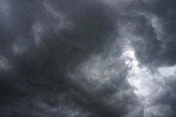 Dark, grim, stormy, rainy sky with rays of light. Scary hurricane clouds. Natural element. Stock...