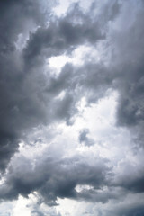 Dark, grim, stormy, rainy sky with rays of light. Scary hurricane clouds. Natural element. Stock Photo for your design
