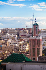 Old mosque with new buildings in the background