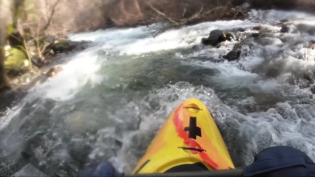 Whitewater kayaking on a cold spring day. Applegate River in Northern California