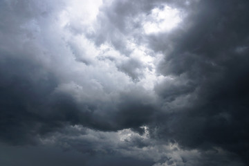 Dark, grim, stormy, rainy sky with rays of light. Scary hurricane clouds. Natural element. Stock Photo for your design