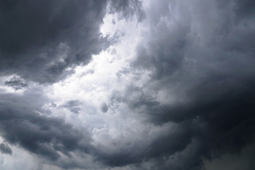 Dark, grim, stormy, rainy sky with rays of light. Scary hurricane clouds. Natural element. Stock...