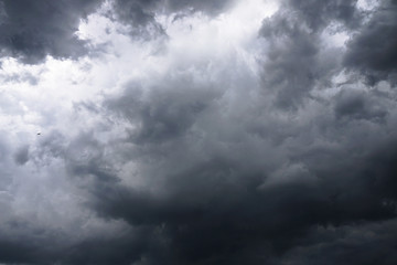 Dark, grim, stormy, rainy sky with rays of light. Scary hurricane clouds. Natural element. Stock Photo for your design