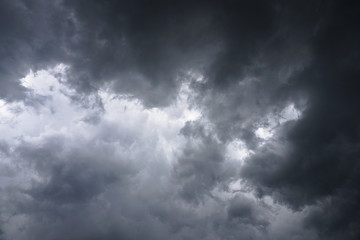 Dark, grim, stormy, rainy sky with rays of light. Scary hurricane clouds. Natural element. Stock Photo for your design
