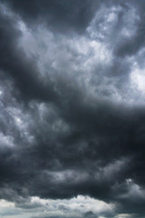 Dark, grim, stormy, rainy sky with rays of light. Scary hurricane clouds. Natural element. Stock...