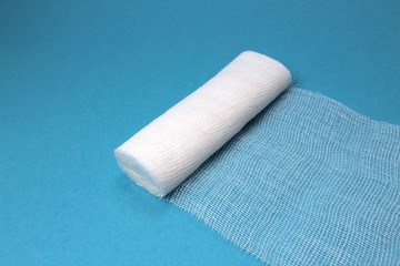 White sterile medical bandage on a blue background
