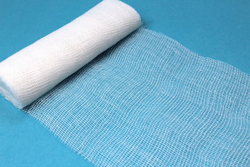 White sterile medical bandage on a blue background