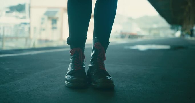 Close up on the feet of woman standing on train station platform