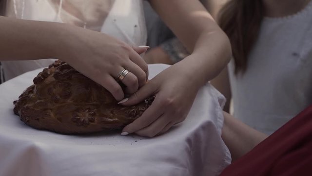 Fresh bread with salt inside holds a woman.