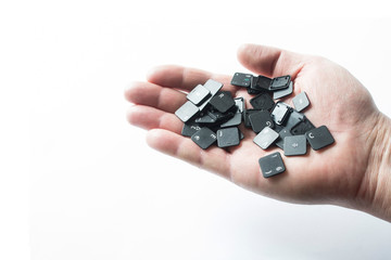 Keyboard buttons in hand on a white background.