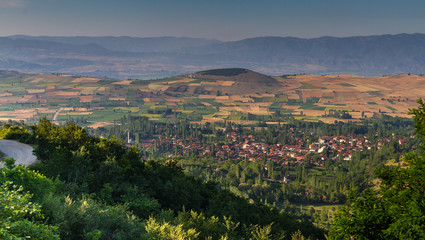 Fototapeta premium Mountains, farm fields and village 