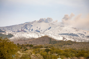 Etna Volcano with smoke in winter, volcano landscape from Catania, Sicily island, Italy