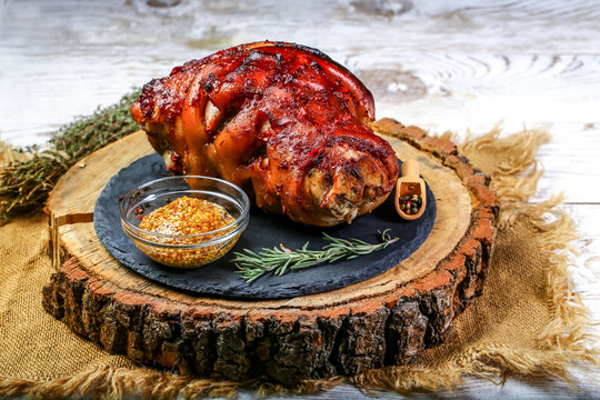 German food concept. Roasted Pork knuckle with sauerkraut. Cooking Bavarian pork knuckle