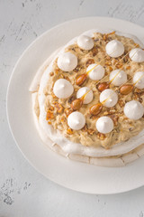 Pavlova cake with caramel and almonds