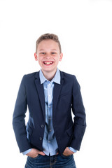 Boy in blue shirt and blue jacket laughs frontally into the camera