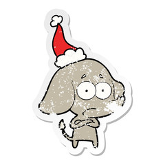 distressed sticker cartoon of a unsure elephant wearing santa hat