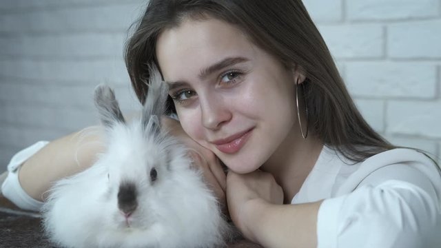 Girl with Easter bunny. Adorable girl with a fluffy white rabbit.