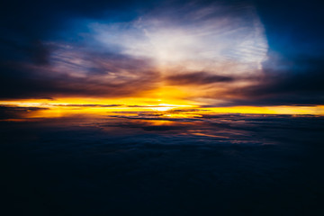 Fototapeta na wymiar Beautiful and colorful sunset above the clouds