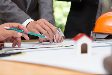 Architects engineer discussing on desk with blueprint. Team group on construciton site check documents and business workflow.Construction concept. Engineering tools.Vintage effect.Selective focus.