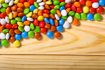 colorful chocolate candies on wooden background