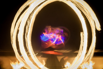 Amazing fire show dance. Fire dancers in beautiful costumes playing with flame