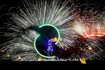 Amazing fire show dance. Fire dancers in beautiful costumes playing with flame