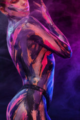 Fototapety  Young woman painted different colors. Inspired dance to music. Body art colorful. An amazing woman with art fashion makeup and bodyart.