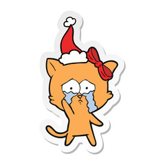 sticker cartoon of a cat wearing santa hat