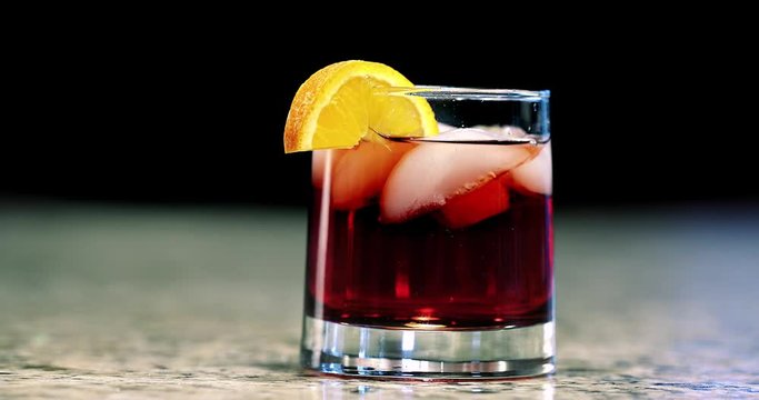 Mixed cocktail sliding on bar