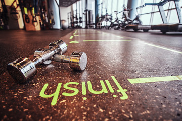 Sport, fitness, health. Dumbbells lying on the floor in the fitness center