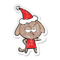distressed sticker cartoon of a bored dog wearing santa hat