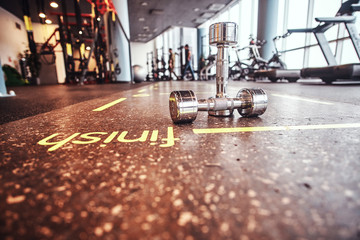 Sport, fitness, health. Dumbbells lying on the floor in the fitness center