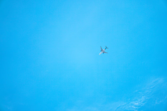 Beautiful blue sky in the clouds and with a small passenger airplane. Colorful tourist landscape - Stock Photo