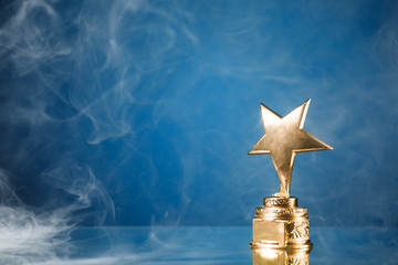 gold star in smoke, blue background