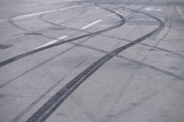 Abstract of Black tire wheels caused by Drift car on the road. Braking at a pedestrian crossing and a road with markings. Stock photo for design