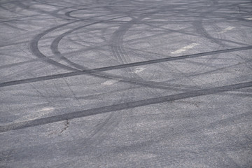 Abstract of Black tire wheels caused by Drift car on the road. Braking at a pedestrian crossing and a road with markings. Stock photo for design
