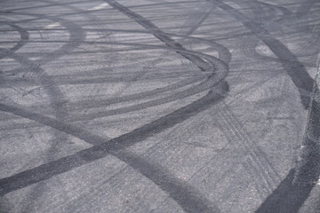 Abstract of Black tire wheels caused by Drift car on the road. Braking at a pedestrian crossing and a road with markings. Stock photo for design