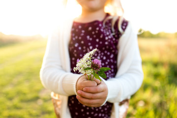 Close up of girl holding flowers