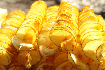 Fried potato chips on a skewer, crispy and delicious