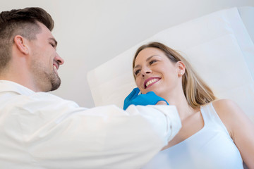 Fototapeta premium Young doctor doing skin treatment with hyaluronic acid injections on the face of young woman