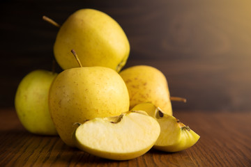 Yellow apple on the wooden vintage background