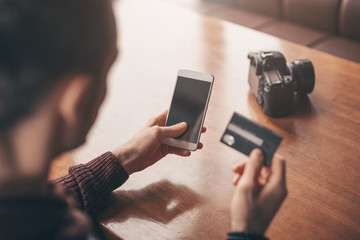 Online banking with smart phone, man photographer rewrite a number of credit card