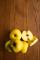 Yellow apple on the wooden vintage background