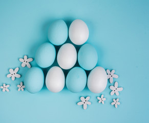 Spring and Easter holiday concept. Easter eggs painted blue and white, pastel color background. Isolated on white.