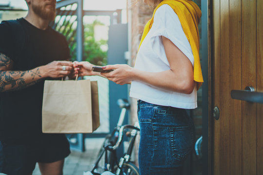Courier delivery food service at home. Man courier delivered the order no name bag with food.