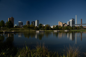 Fototapeta na wymiar Birmingham, Alabama skyline reflects on a pond in Railroad Park